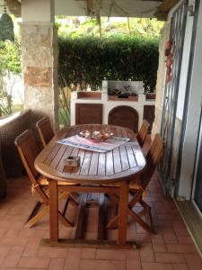 a wooden table and chairs on a patio at Villa sul mare in Briatico