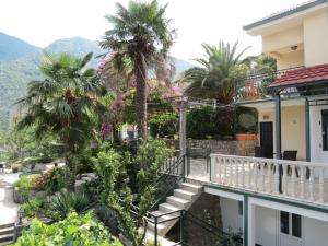 a view from the balcony of a house with palm trees at Apartment Capt Seferovic 2 in Donji Morinj