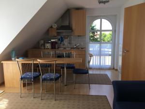 een keuken met een tafel en stoelen in een kamer bij Ferienwohnung Tietgens in Hohenfelde