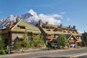 a large building with a view of a mountain range at Fox Hotel and Suites in Banff