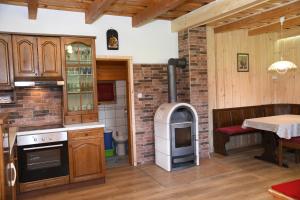 a kitchen with a brick wall and an oven at POČITNIŠKA HIŠA JURČEK POKLJUKA in Goreljek