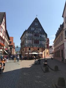 a large building in the middle of a street at Main Boarding House in Miltenberg