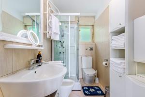 a bathroom with a sink and a shower and a toilet at Jasmina apartment in Rijeka +33 photos