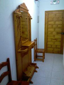 Habitación con estante de madera y puerta en Pensión Ignacio, en Aljaraque