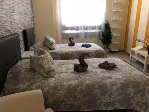 two beds in a hotel room with two beds with slippers at Vivienda Sara in Valle Gran Rey