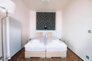 A bed or beds in a room at K-Triumf Resort