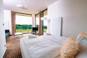 A bed or beds in a room at K-Triumf Resort
