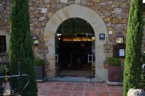 an entrance to a building with an archway at Hotel Galena Mas Comangau in Begur