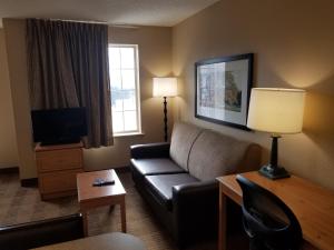 a living room with a couch and a tv at Extended Stay America Suites - Milwaukee - Brookfield in Brookfield