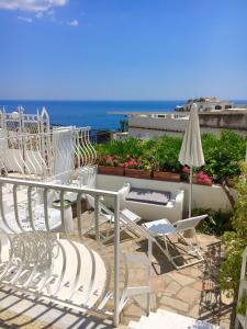 a row of chairs and an umbrella on a patio at Hotel Villa Delle Palme in Positano in Positano