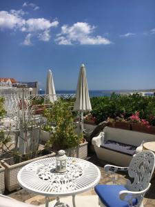 a patio with a table and chairs and the ocean at Hotel Villa Delle Palme in Positano in Positano