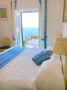 a bedroom with a bed with a view of the ocean at Hotel Villa Delle Palme in Positano in Positano
