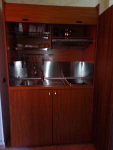 a kitchen with a sink in a wooden cabinet at Agriturismo Casalino in Beverino