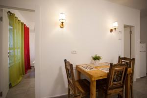 a dining room with a wooden table and chairs at Desert Moments in Yeroẖam