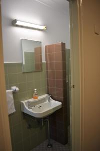 a bathroom with a sink and a mirror at Figtree Hotel Wollongong in Wollongong