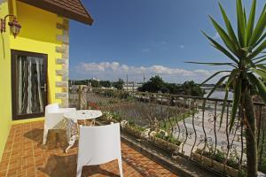 a patio with a table and chairs and a fence at Happiness Pass On in Wujie