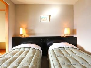 Postel nebo postele na pokoji v ubytování Hotel Silk Inn Madarao