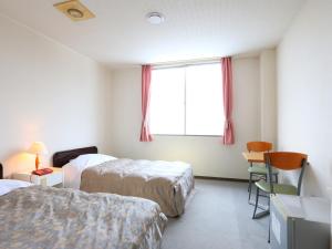Postel nebo postele na pokoji v ubytování Hotel Silk Inn Madarao
