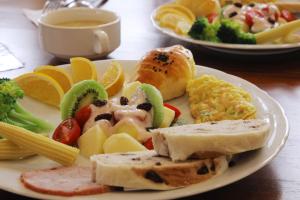 une assiette de nourriture sur une table avec des légumes et des fruits dans l'établissement Happiness Pass On, à Wujie