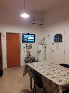 a room with a table and a television on the wall at La Popelina in Valle Hermoso