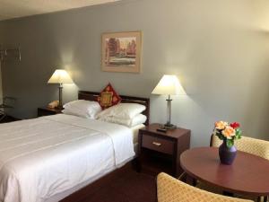 a hotel room with a bed and a table at A1 Choice Inn in Mount Shasta