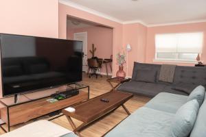 a living room with a large flat screen tv at JstLikeHome - Old Town in Ottawa