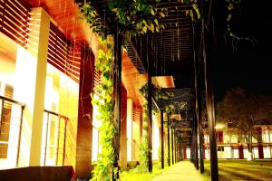 a building with plants growing on the side of it at Intara Resort in Udon Thani