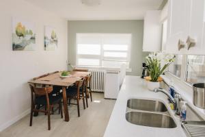 a kitchen with a table and chairs in a kitchen at JstLikeHome - Old Town in Ottawa +14 photos
