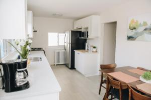 a kitchen and dining room with a table and a black refrigerator at JstLikeHome - Old Town in Ottawa