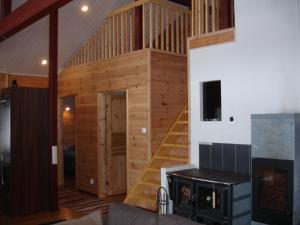 a cabin with a staircase in a living room at Aamuruskon Ukkola Cottage in Sirkkakoski