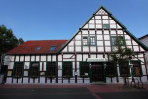 a building with a black and white building at Hotel Altes Gasthaus Schröer in Westerkappeln