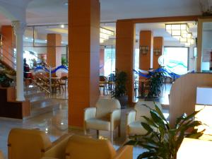 a lobby with chairs and tables in a building at Hotel Costa Brava in Blanes