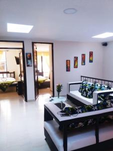 a room with two beds and a room with a hallway at Hotel Dulces Sueños in Santa Rosa de Cabal