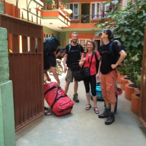 a group of people standing outside a building with their luggage at hotel Backpackers inn in Kathmandu