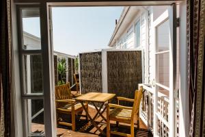 a patio with a table and chairs on a balcony at The Duke Of Marlborough in Russell