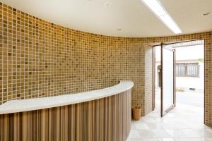 a lobby with a brick wall and a counter at Viale Jurakumawari in Kyoto +42 photos
