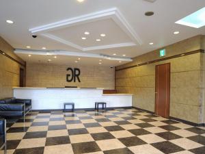 eine Lobby mit einer Bar und einem karierten Boden in der Unterkunft GR Hotel Ginzadori in Kumamoto