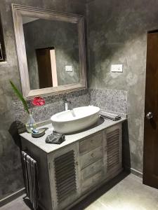 a bathroom with a sink and a mirror on a counter at Temple House Villa in Hikkaduwa
