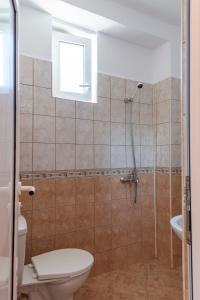 a bathroom with a shower with a toilet and a sink at Gradina in Chernomorets +44 photos