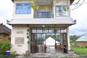 a house with a sign in front of it at Amrita Villa Sidemen in Sidemen