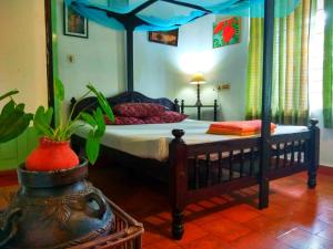 1 dormitorio con 1 cama con dosel en Green Woods Bethlehem en Kochi