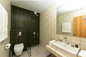 a bathroom with a toilet and a sink at Votsalo in Kavala +19 photos