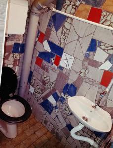 a bathroom with a toilet and a sink at Holiday Home 108 in Bezdan