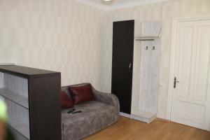 a living room with a couch and a door at Hotel Kavkasioni in Kvareli