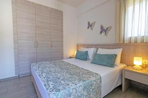A bed or beds in a room at Evgoro Luxury Suites