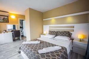 Postel nebo postele na pokoji v ubytování Arsen Hotel