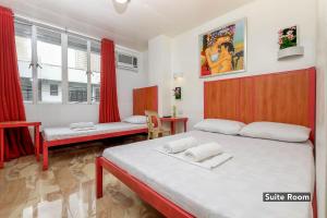 Кровать или кровати в номере Stay Malate (Wanderers Guest House)