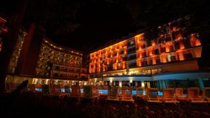 a group of chairs in front of a building at night at The Raga Side Ultra All Inclusive in Side