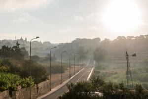 a road with street lights on the side of it at Cesca's Boutique Hotel in Xlendi