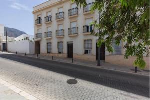 - un grand bâtiment blanc dans une rue pavée dans l'établissement Dalias Beach Apartment, à Dalías
